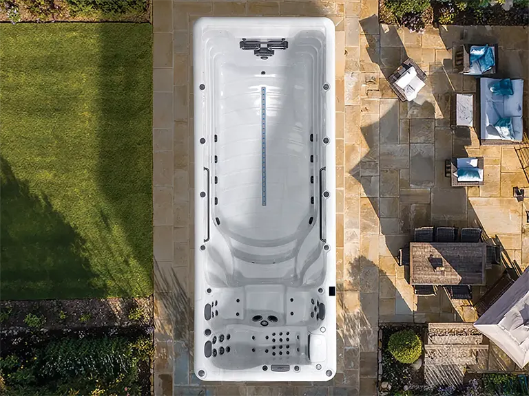 Aerial view of a Platinum Zelus swim spa set into a garden deck