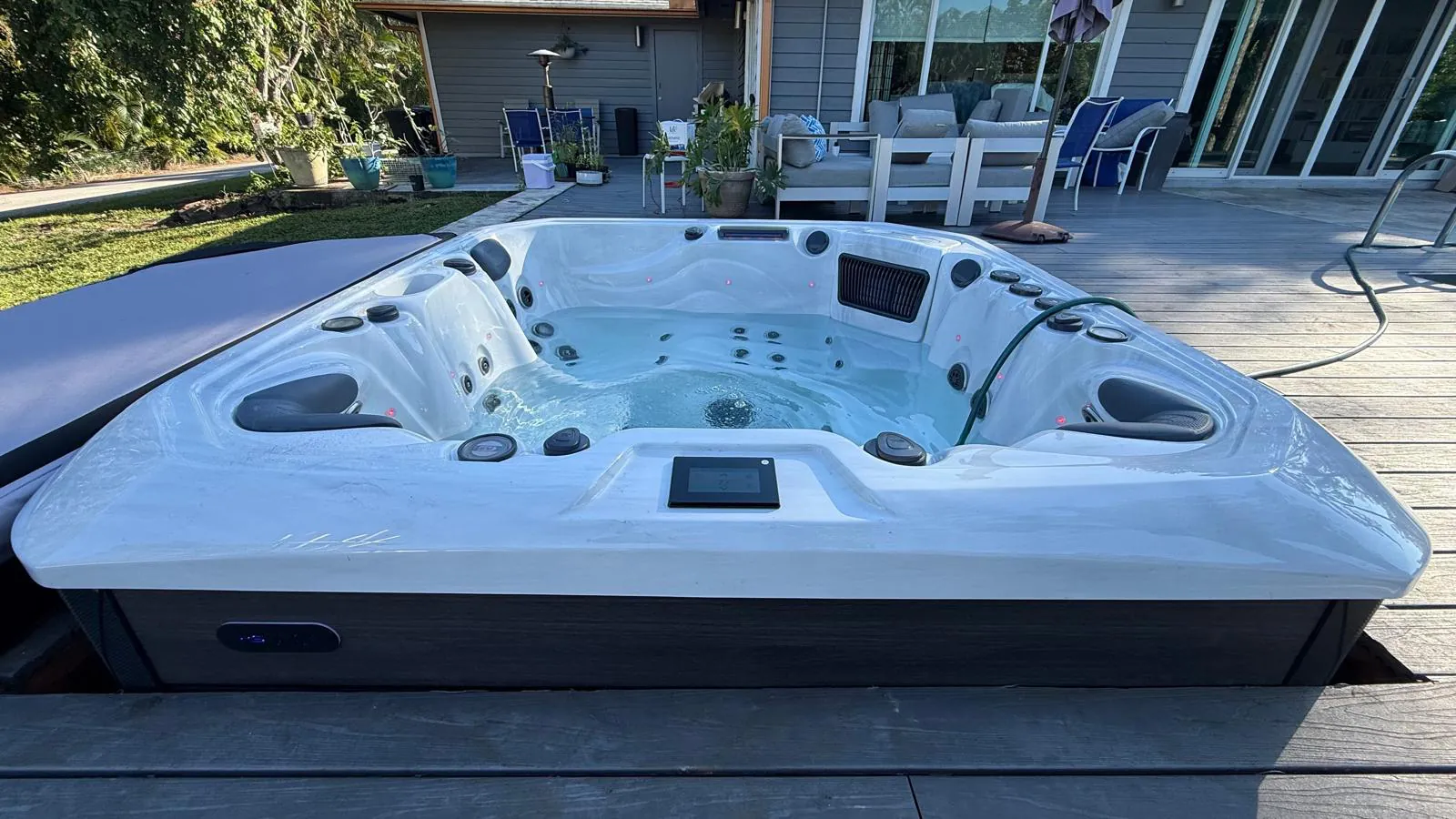 Platinum Palma hot tub set into a wood deck in The Acreage