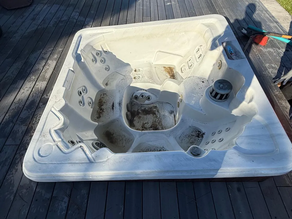 The old hot tub in the same deck before removal