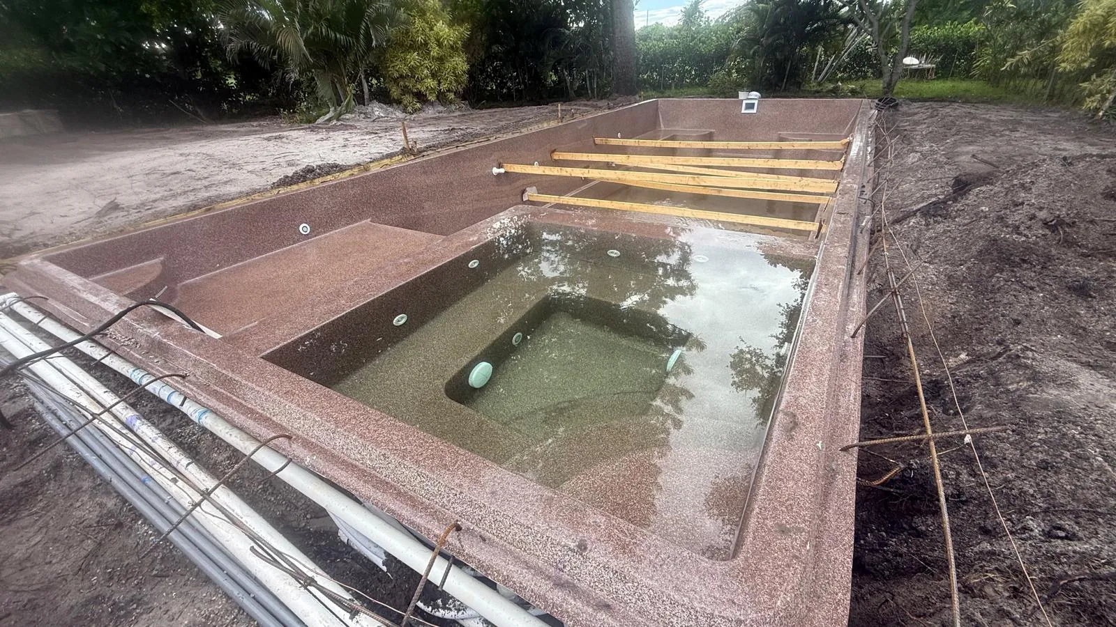 Pool and spa filling with water during backfill
