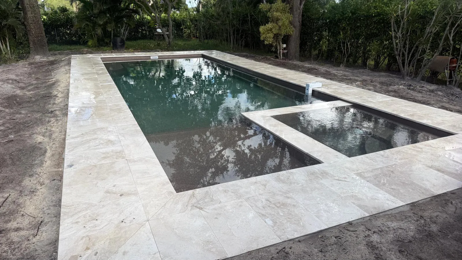 Wide view of the Astoria 14 pool, spa and stone deck