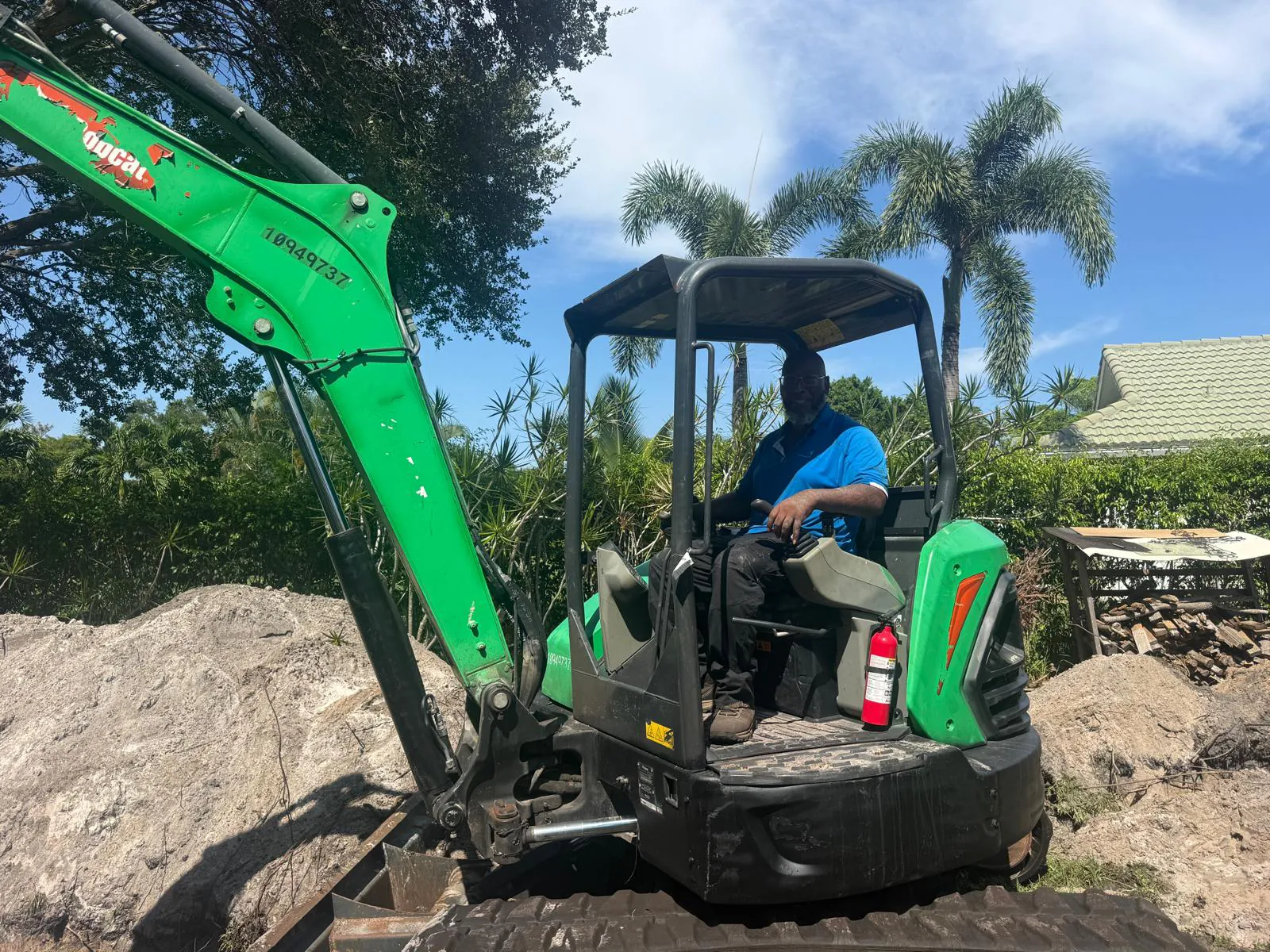 Excavator digging the pool site in the Boca Raton backyard
