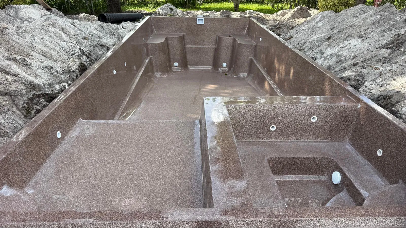 Coastal bronze Astoria 14 shell with its built-in spa in the ground