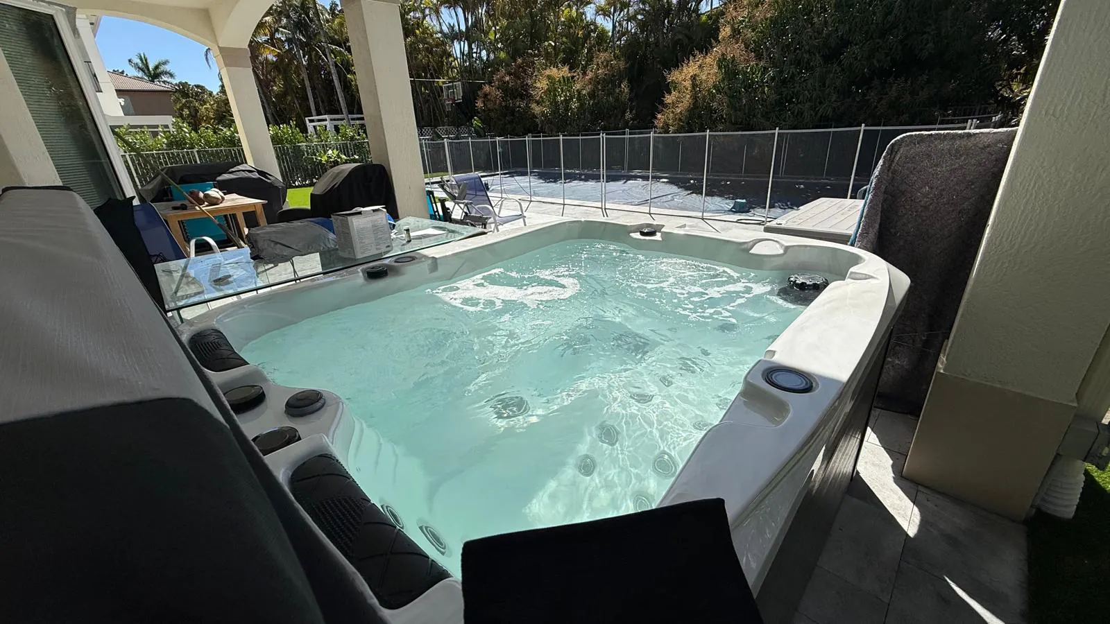 Be Well O354 on the patio with the pool area beyond