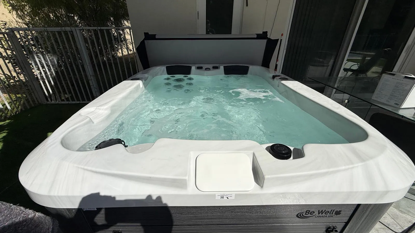 Be Well O354 hot tub beside a house in Boca Raton