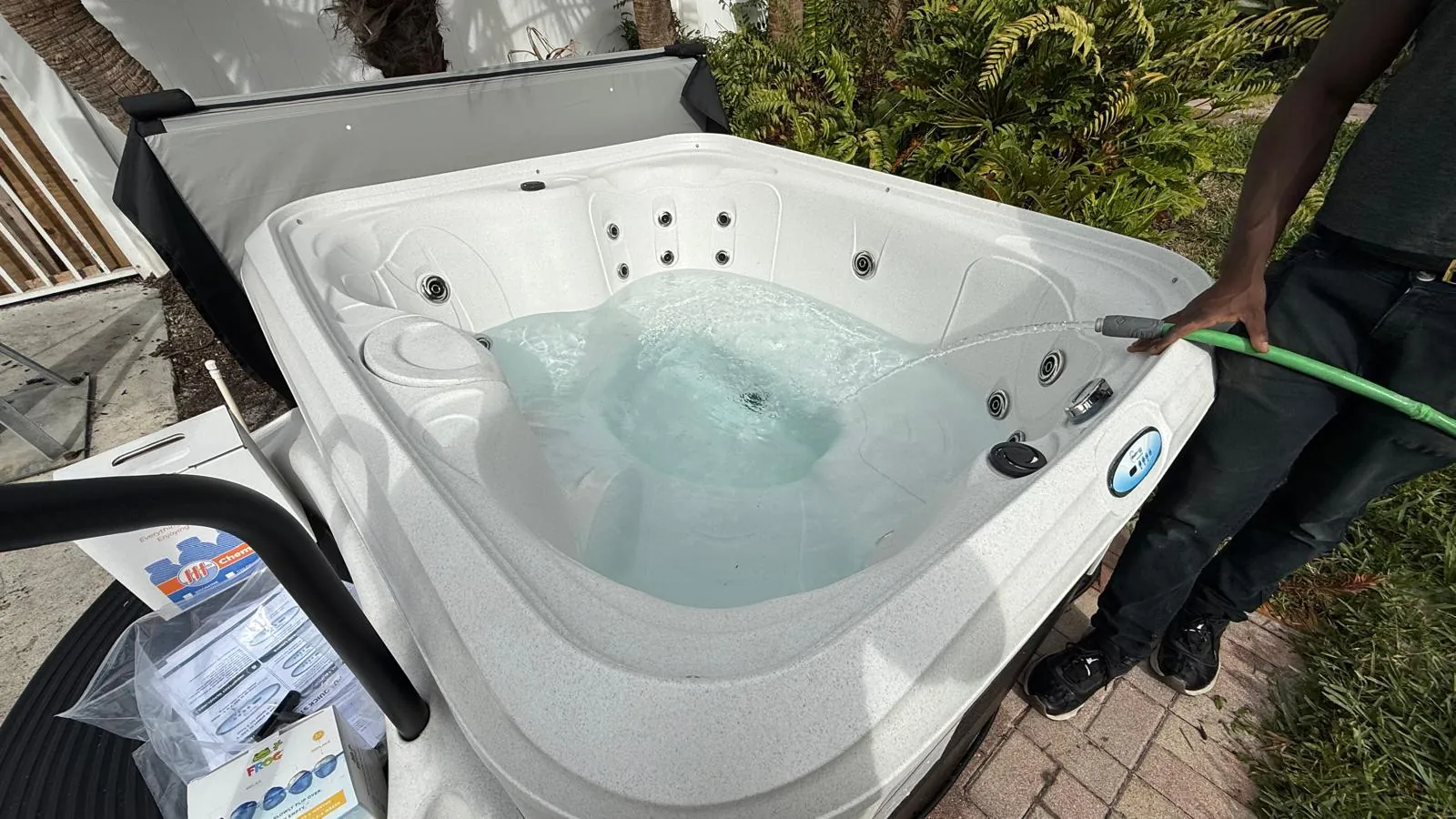 Plug-and-play hot tub being filled with a garden hose