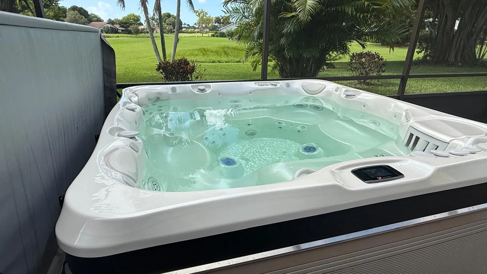 Caldera hot tub filled, on a screened patio