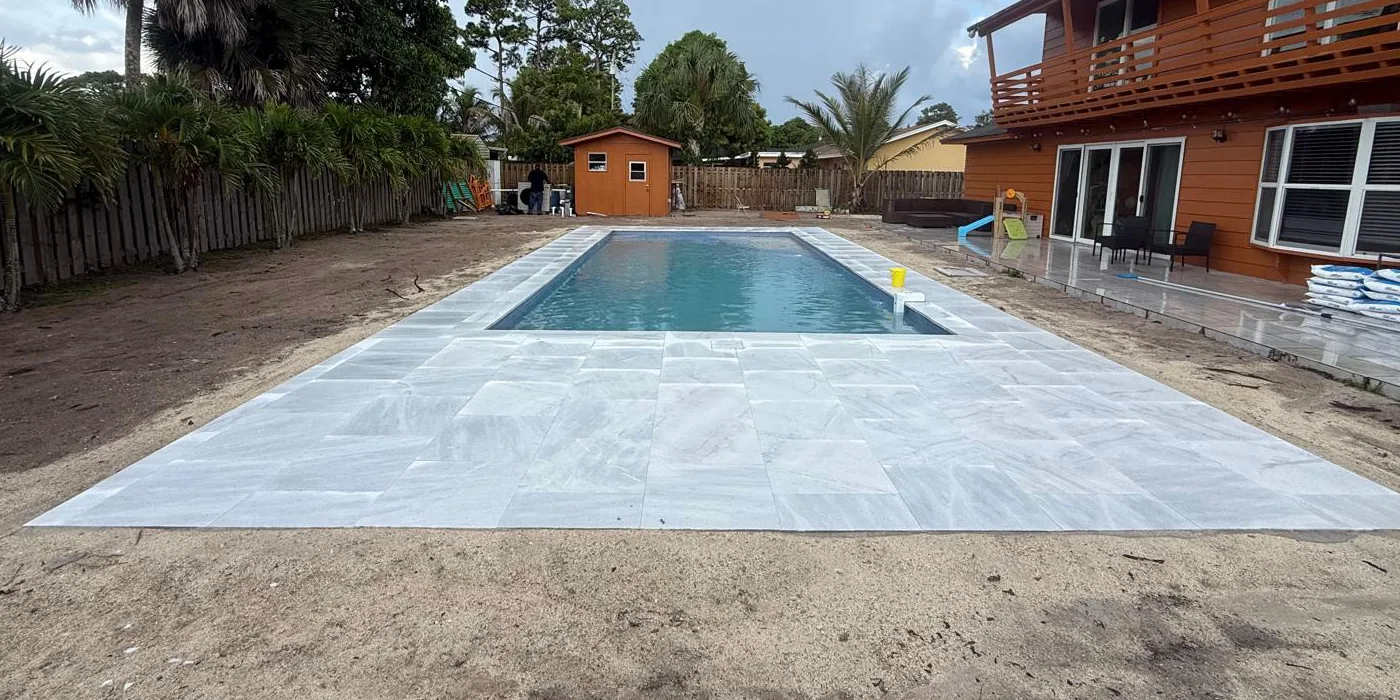 Finished fiberglass pool with paver decking
