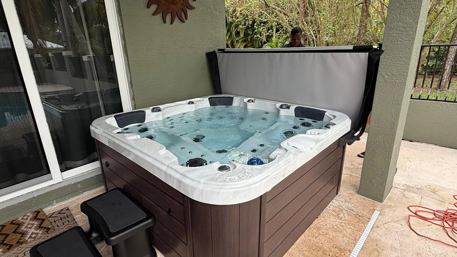 Be Well O578C hot tub delivered under a covered patio in Greenacres