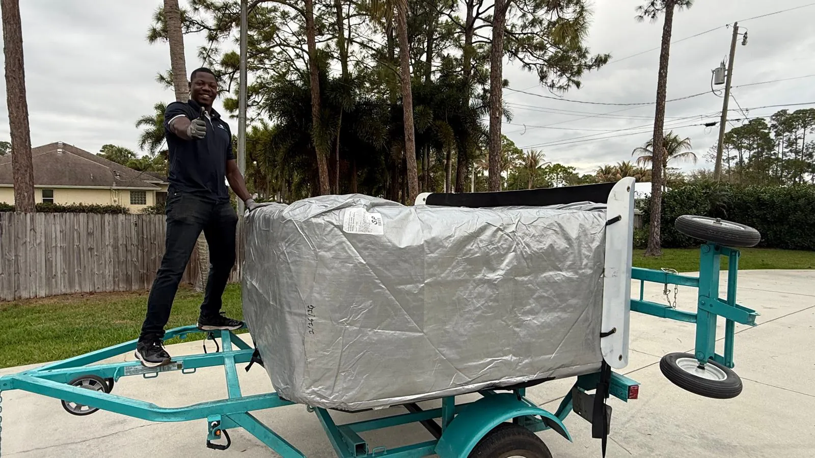 The same hot tub arriving wrapped on a spa trailer