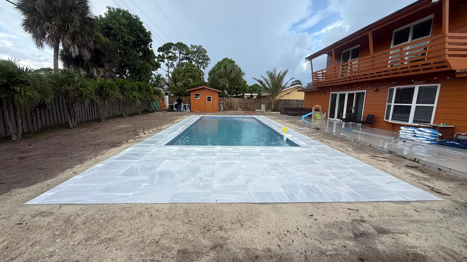 Latham Olympia 16 pool with an ice white marble deck in Haverhill, West Palm Beach