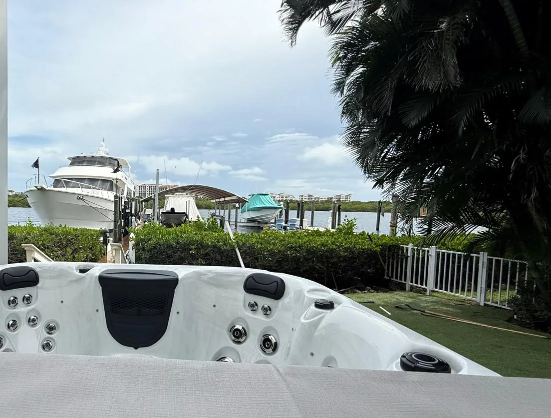 Platinum Reims hot tub on a waterfront lot in Jupiter