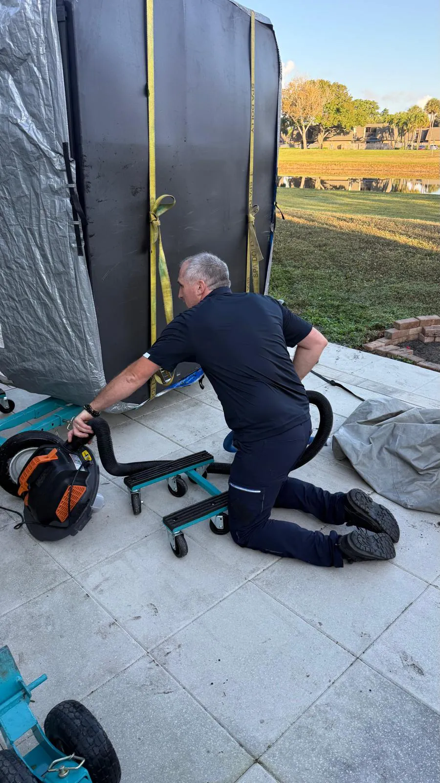 Crew member inflating the air cushion with a blower