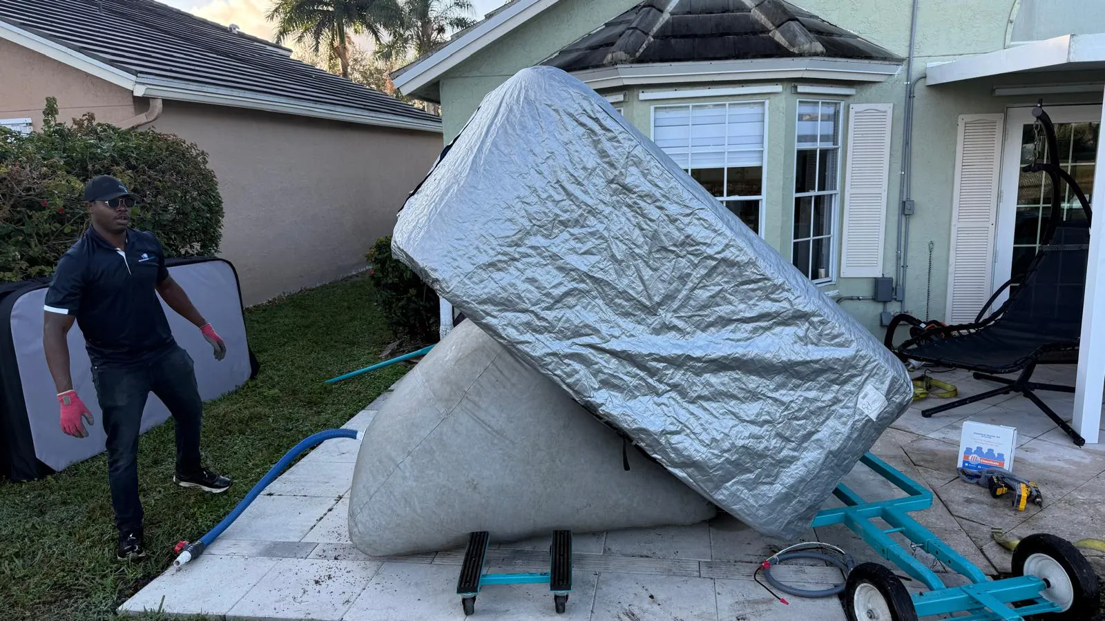 Hot tub being lowered onto the inflated cushion