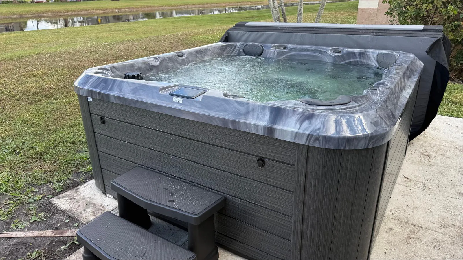 Maple M620 hot tub in storm cloud color on a patio in Lake Worth