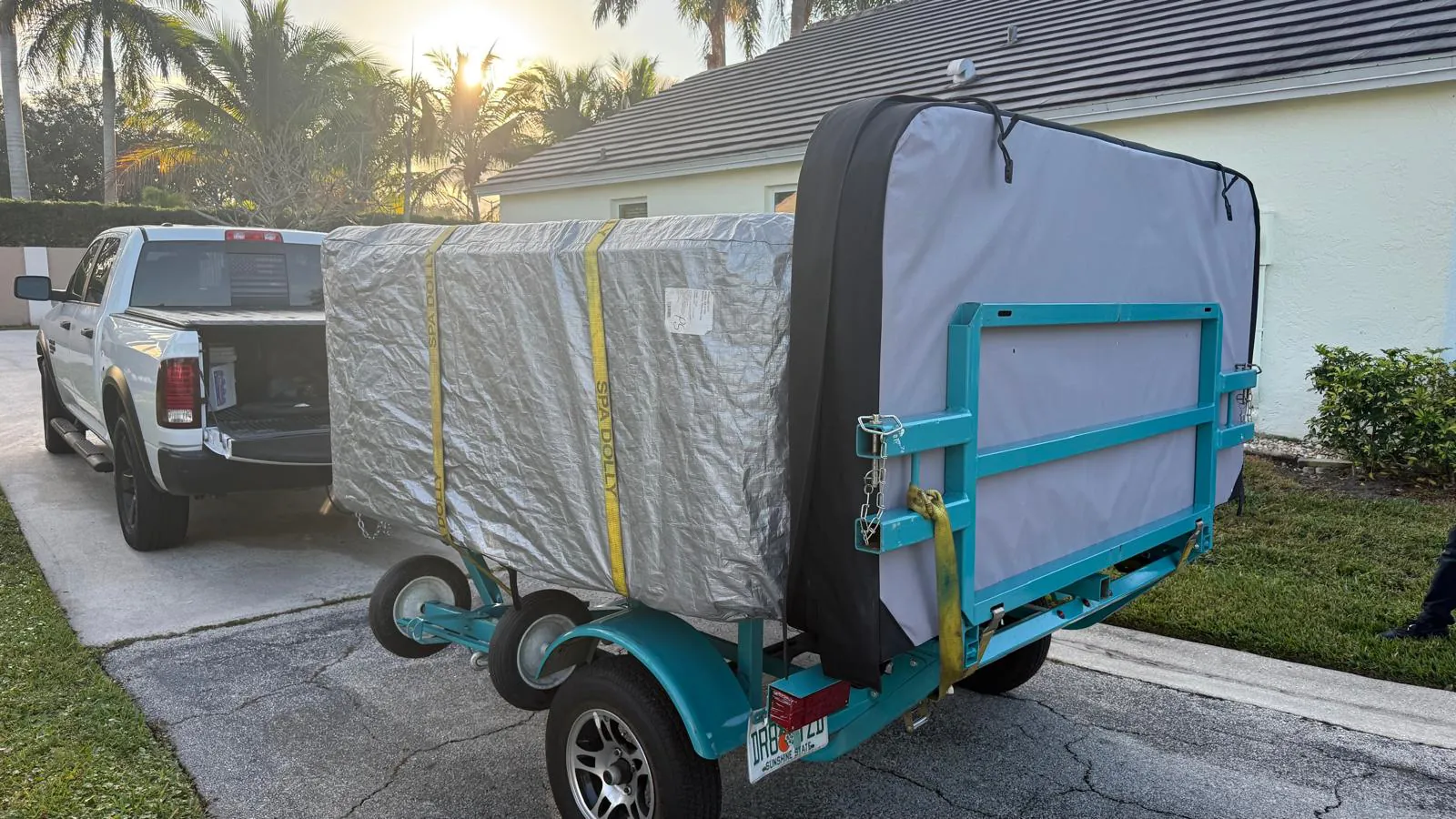 Wrapped M620 on its side on the spa trailer with its cover alongside