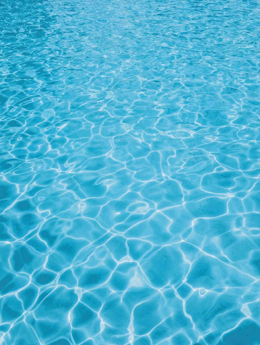 Water over a Latham Sapphire Blue fiberglass pool shell