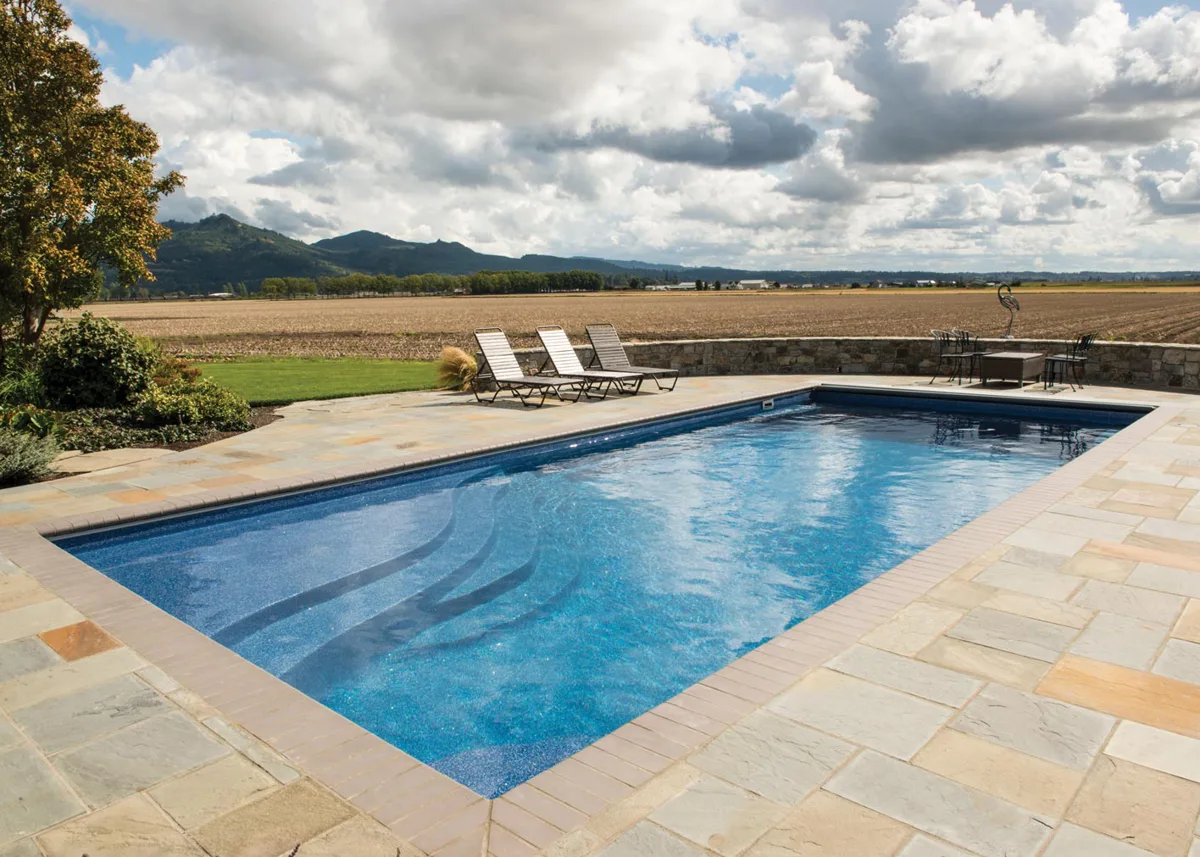 Latham Olympia 16 fiberglass pool installed in a backyard