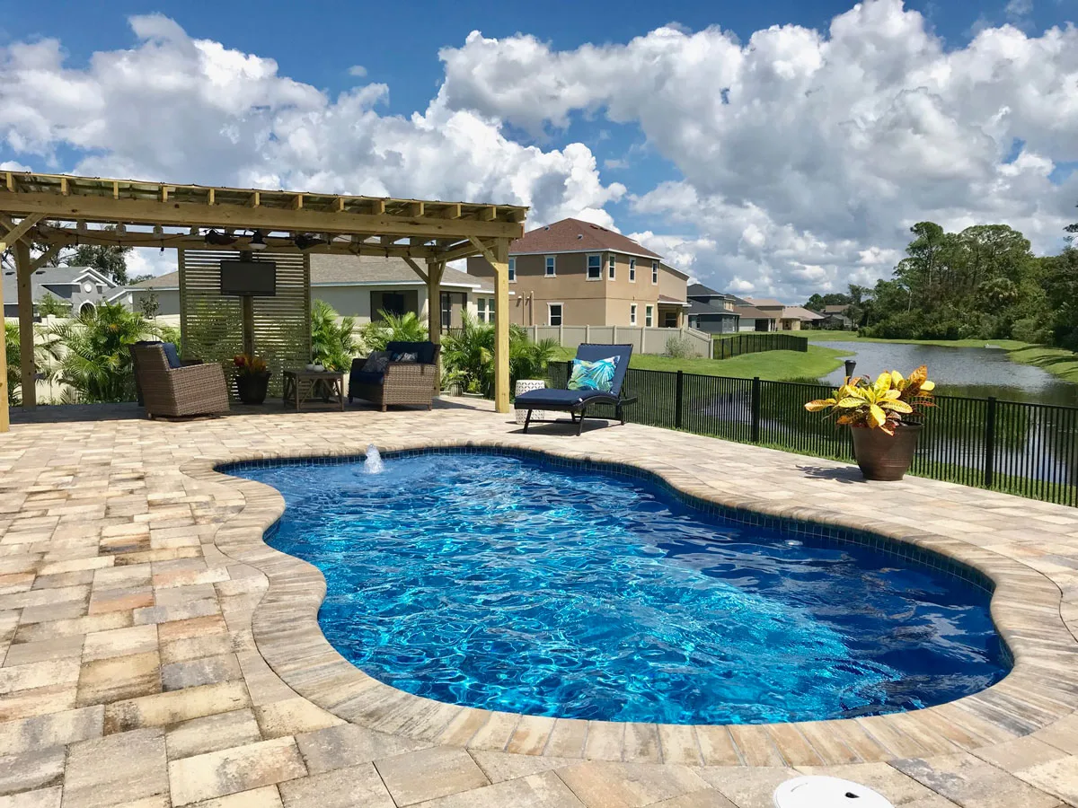 Latham Pleasant Cove fiberglass pool installed in a backyard
