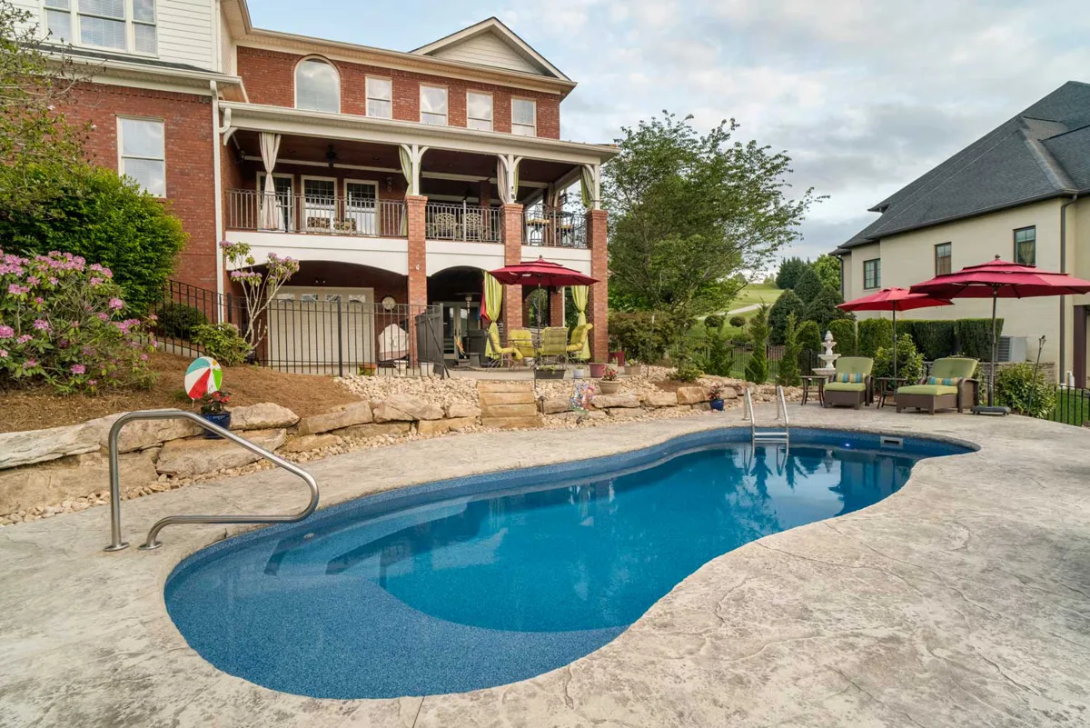 Latham Vista Isle fiberglass pool installed in a backyard