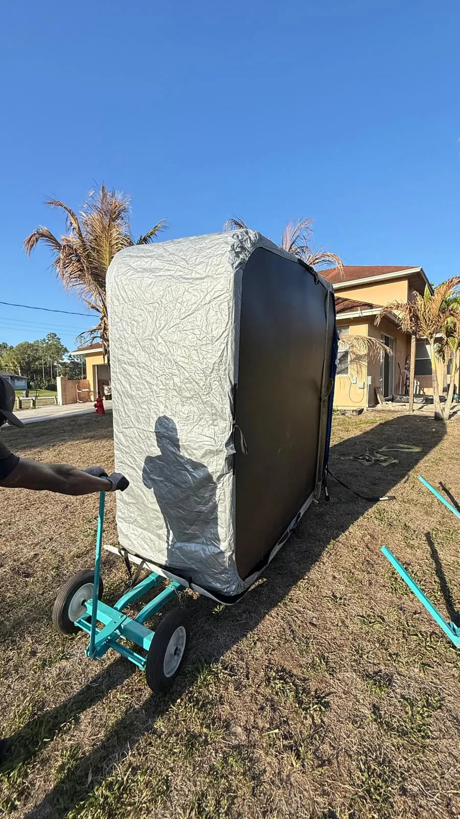 Hot tub stood on its side on a spa dolly