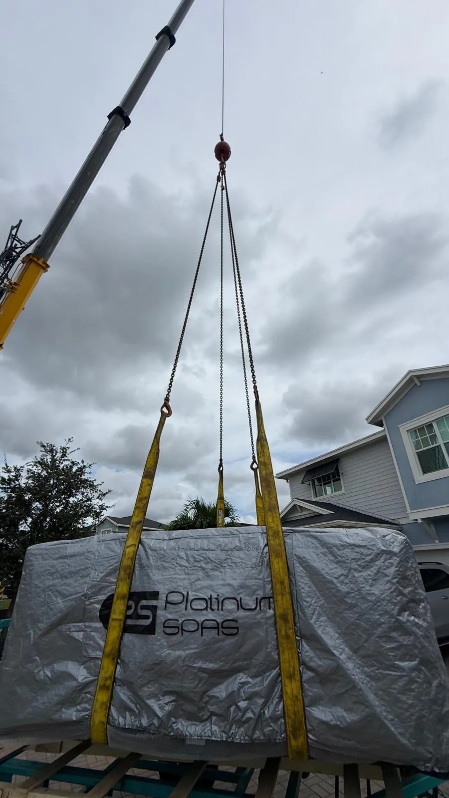 Lifting slings attached to the wrapped spa