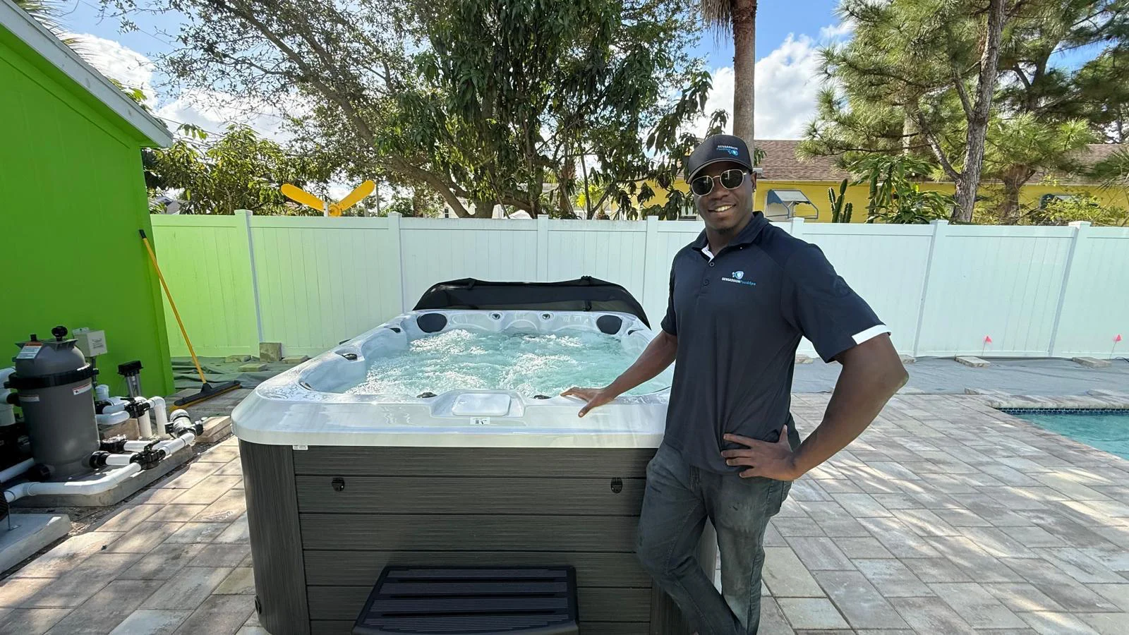 Marquise, Sales Manager at Sensassion Pools and Spa, beside a newly installed hot tub