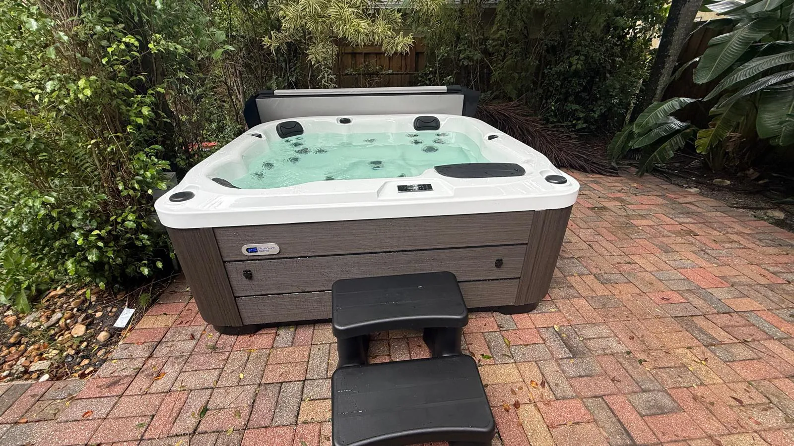 Platinum Reims hot tub on a brick patio in a Palm Beach garden