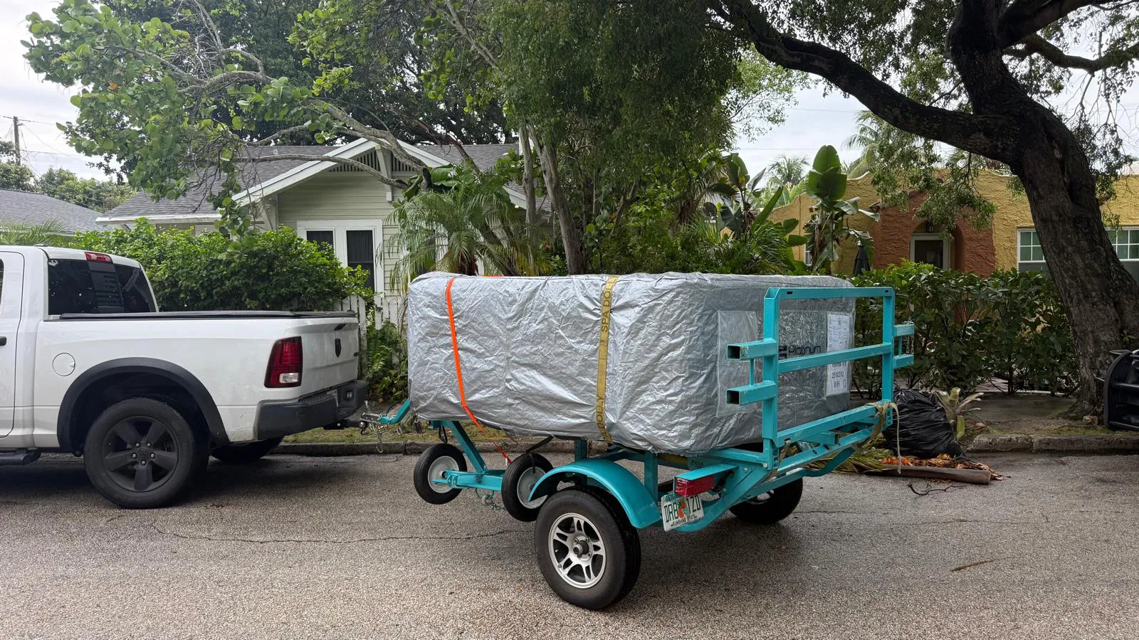 The same hot tub arriving wrapped on a spa trailer