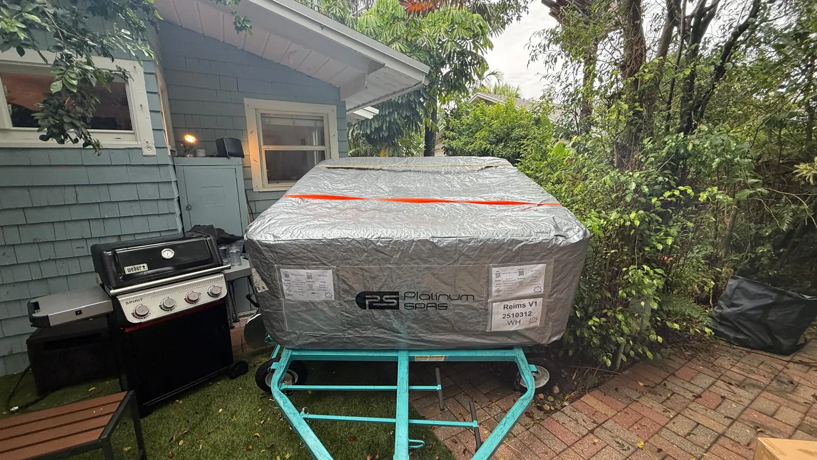 Wrapped Platinum Reims on the trailer frame beside the house