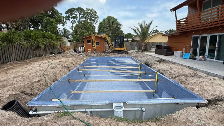 Fiberglass pool shell braced during backfill
