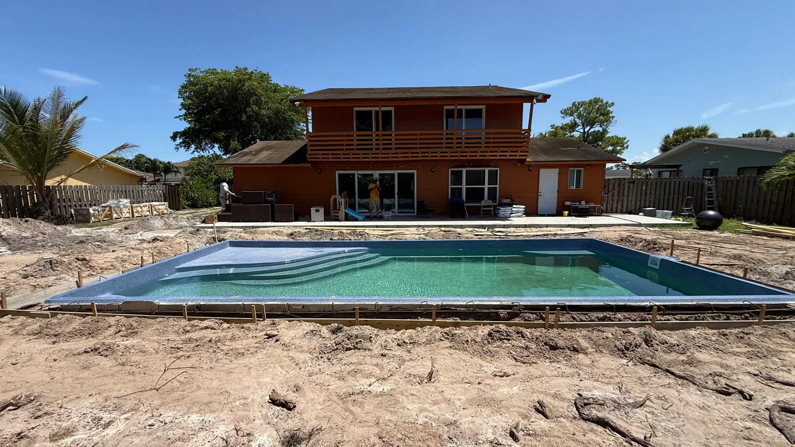 Fiberglass pool being filled after the shell is set