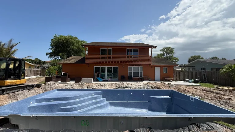 Fiberglass pool shell set in front of the house