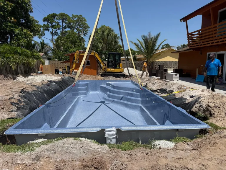 Fiberglass pool shell in place, seen from the deep end