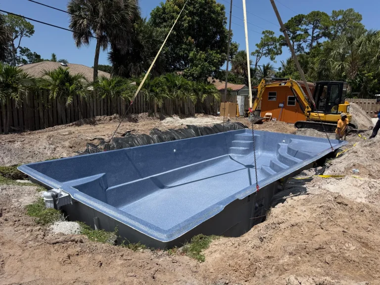 Fiberglass pool shell set in the excavation