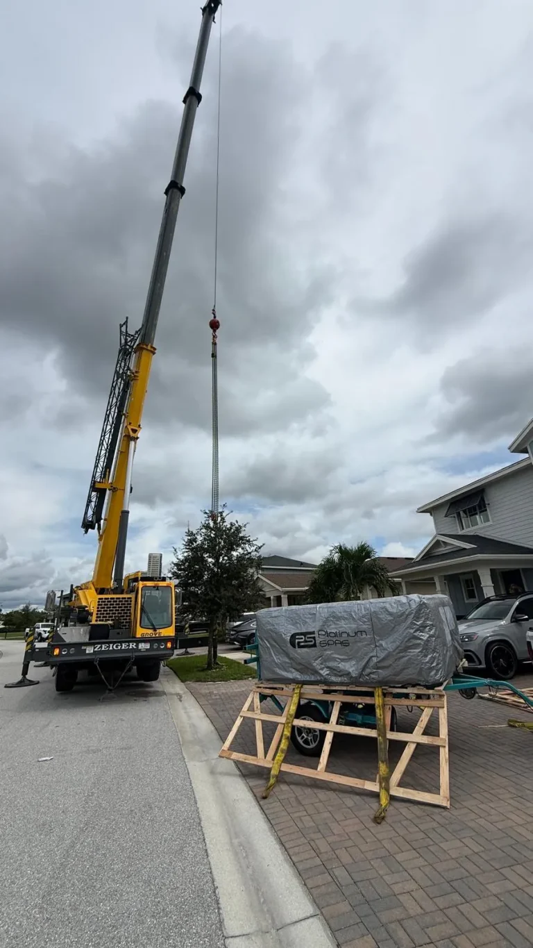 Crane set up in the street for a hot tub delivery