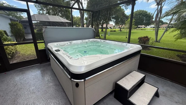 Hot tub with steps inside a screen enclosure