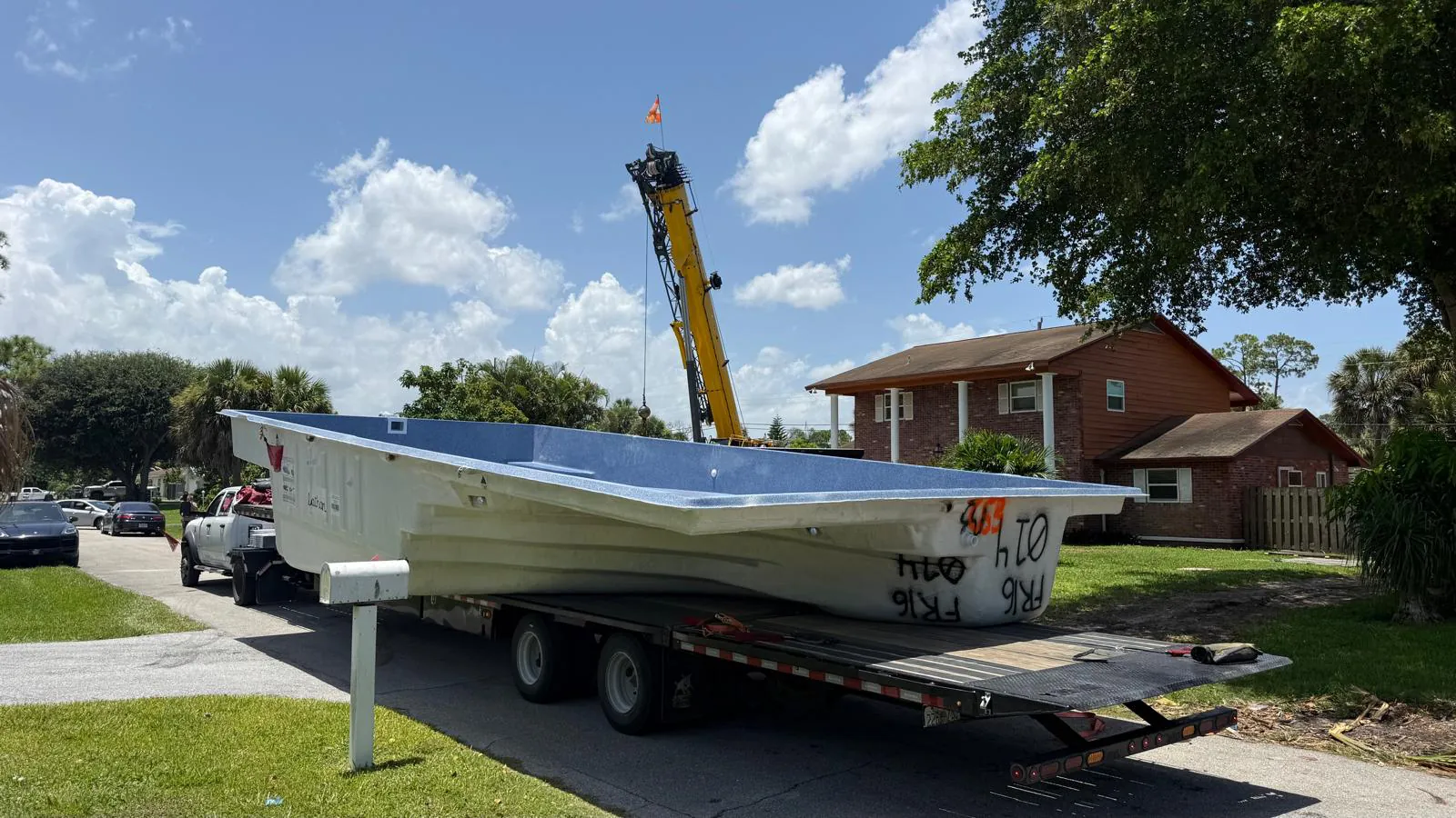 Fiberglass pool shell arriving on a trailer