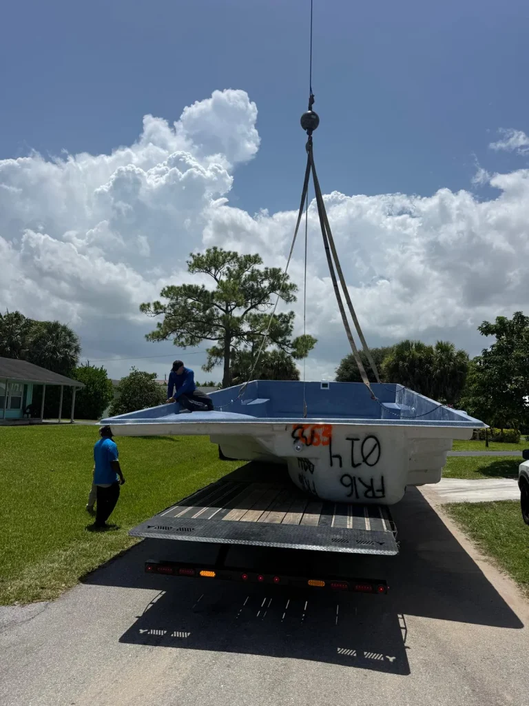 Fiberglass pool shell lifted off the trailer