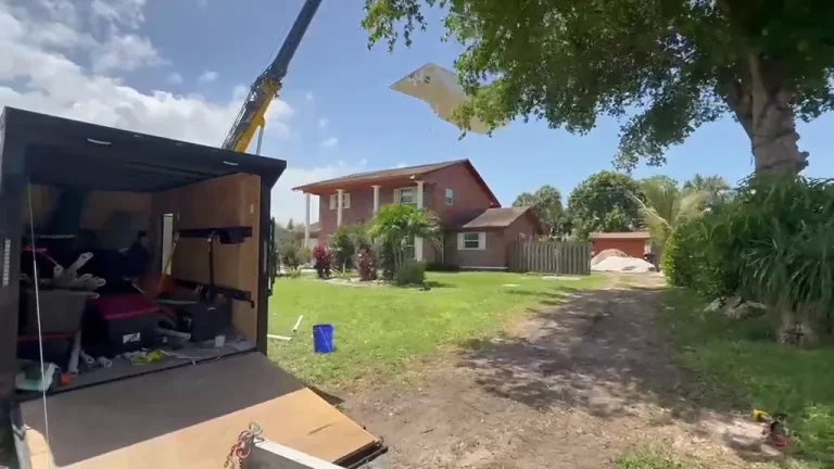 Video: fiberglass pool shell lifted over the house