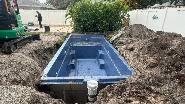 Compact fiberglass pool shell in its excavation