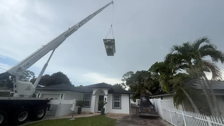 Spa lifted by crane over a house