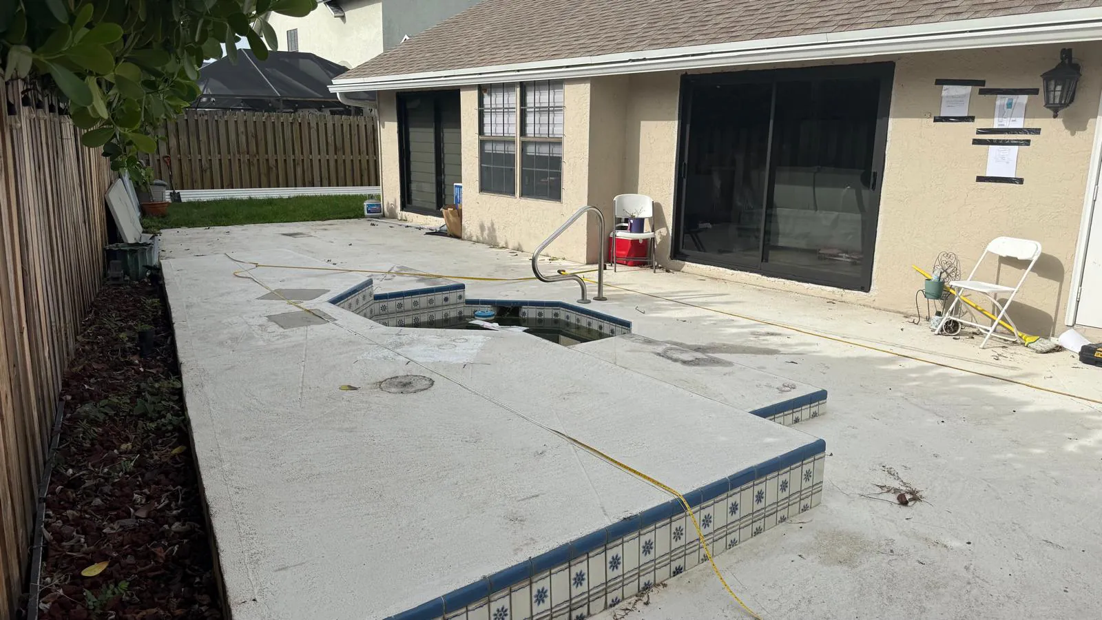 The same Wellington backyard before the project, with the old concrete spa