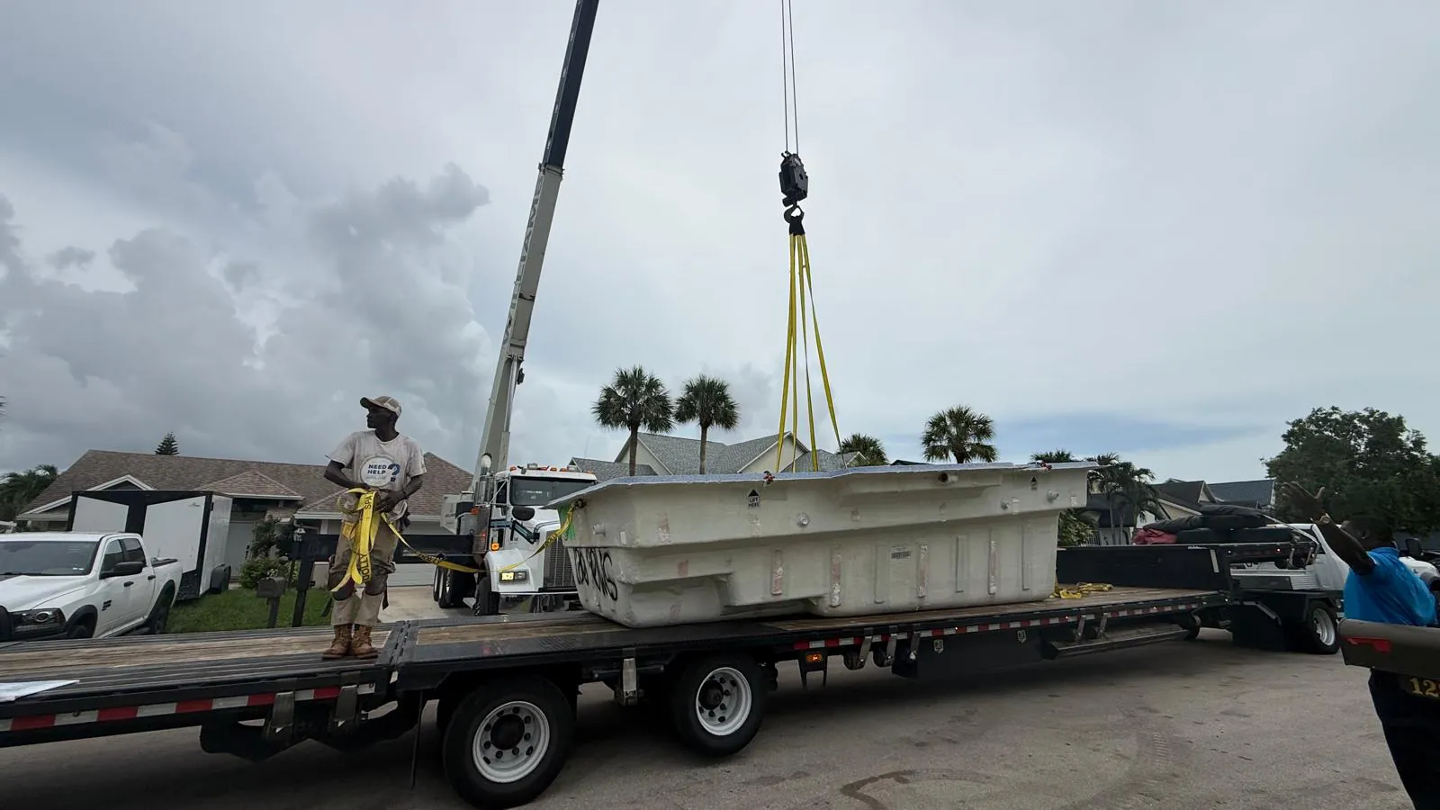 Tuscan 11.20 shell on a flatbed trailer beside the crane
