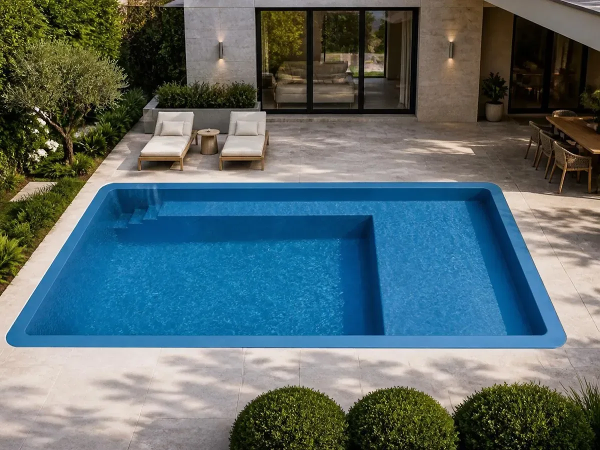 X-Pools Austin fiberglass pool with a shallow beach entry and bench