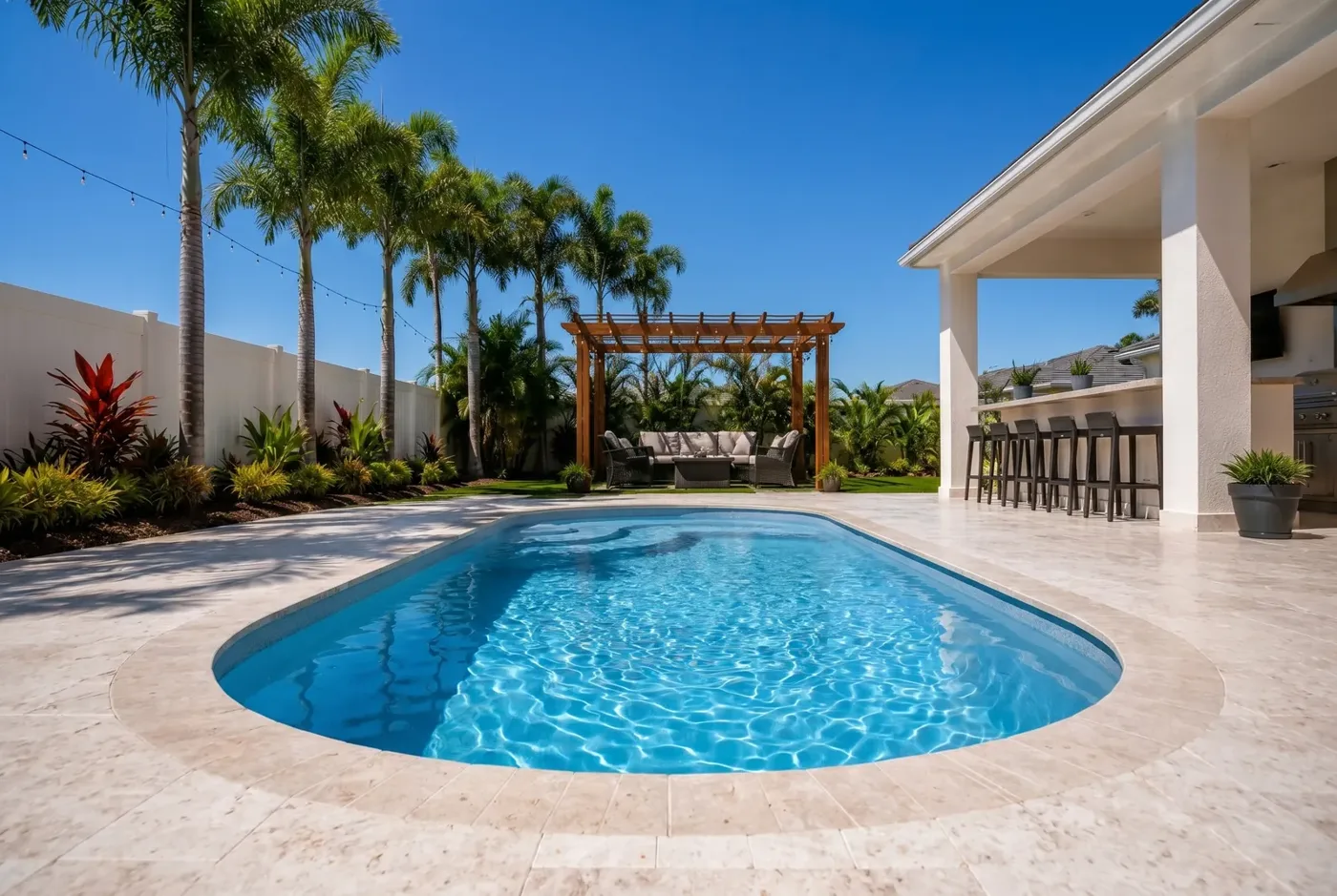X-Pools Naples freeform fiberglass pool with palms and a pergola