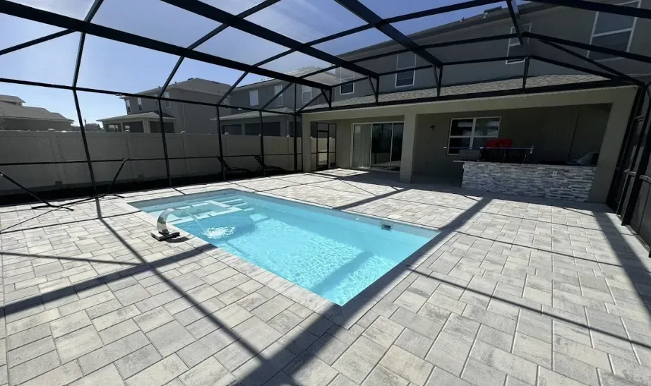 X-Pools X-Line 7 with integrated spa inside a screened patio