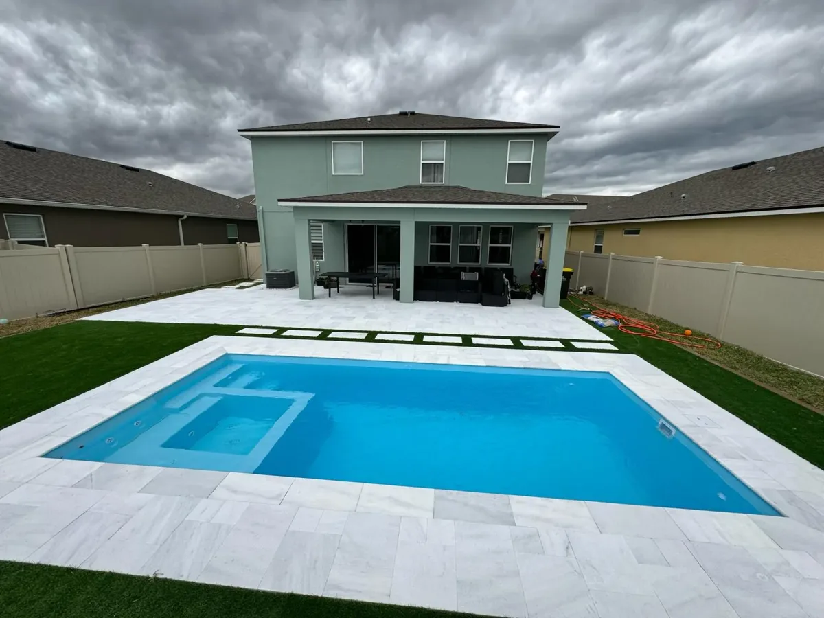 X-Pools X-Line 7 fiberglass pool with integrated spa behind a modern home